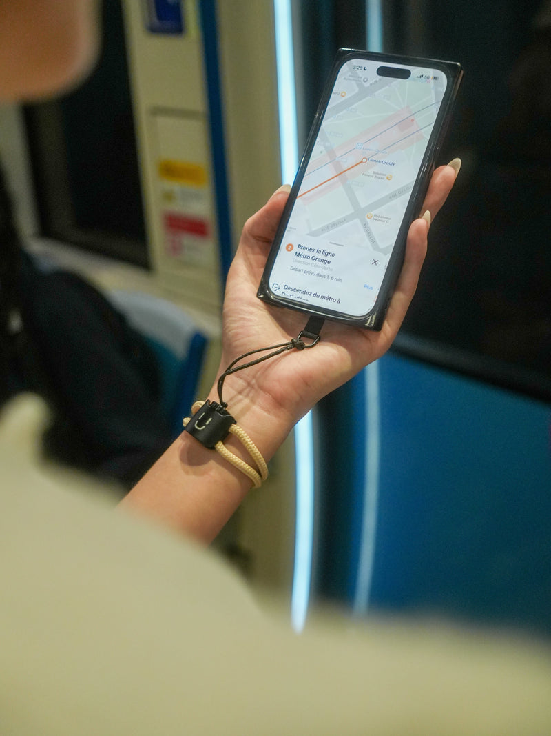 Préparer son téléphone avant un voyage : bracelet LOCKÜP au poignet d'une voyageuse